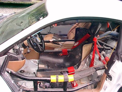 1995 Ford Mustang - The interior of a 1995 Ford Mustang Cobra R shows racing modifications including a roll cage and racing seat.