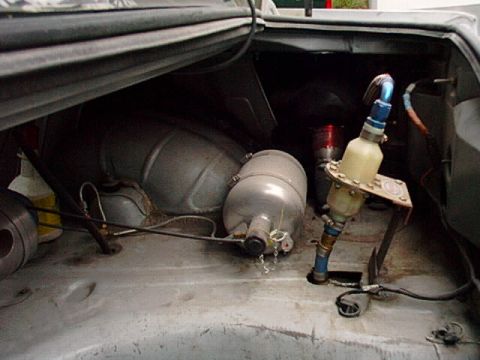 1995 Ford Mustang - Trunk interior shows a fuel cell and pump assembly, suggesting modifications for racing or performance.