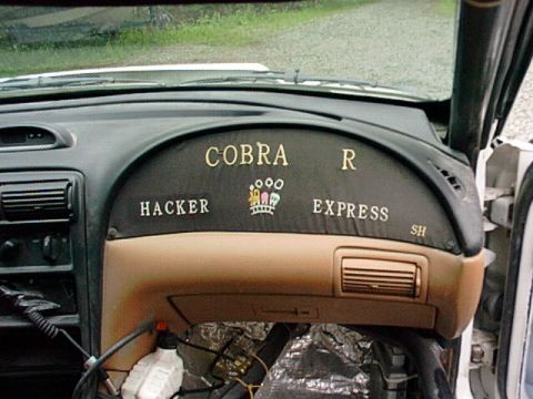 1995 Ford Mustang - Interior view of a vehicle's dashboard displaying custom text and a logo.
