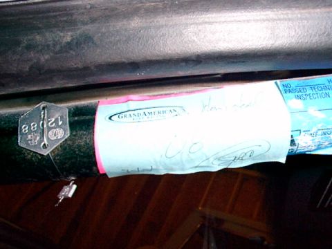 1995 Ford Mustang - Close-up of a vehicle's inspection tag and sticker with handwritten notes and a stamped number.