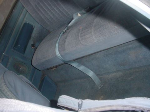 1988 Ford Bronco - Interior view of a 1988 Ford Bronco, highlighting the blue upholstery and seatbelt system.