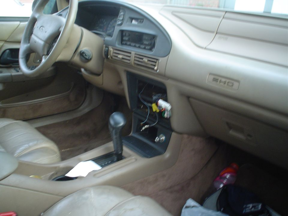 Tan interior of a sedan with SHO dash badge and the center console trim removed