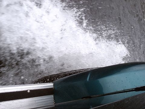 1996 Ford Bronco - A vehicle splashes through water, obscuring the view ahead.