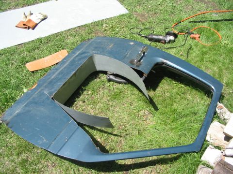 1986 Ford Bronco - A teal car door, possibly modified, rests on a grassy surface with tools nearby.