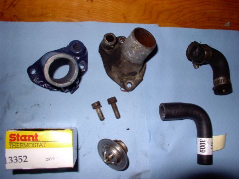 1986 Ford Bronco - My T-stat housing was so corroded the hose wouldn't seal. New painted off-shore unit and bypass hose. Note the shorter bolt. I cut it to ma…
