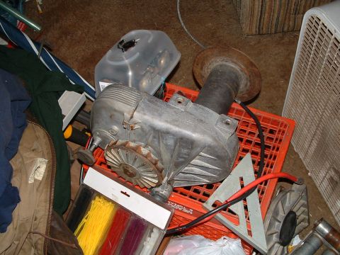 1979 Ford Bronco - A winch assembly is shown on an orange crate, surrounded by various items.