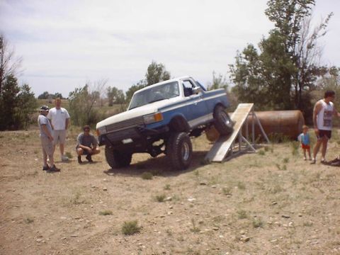 1988 Ford Bronco - Pickup truck on an obstacle course ramp. The truck appears to be from the late 1980s.