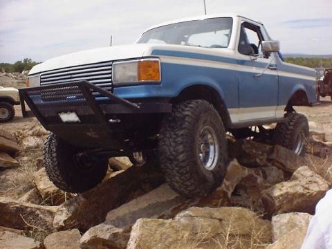 1988 Ford Bronco - Modified Ford Bronco navigating a rocky obstacle course.
