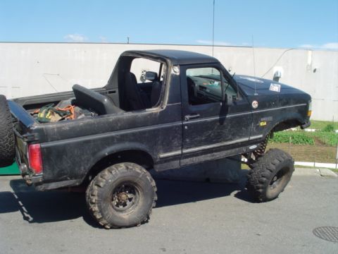 1993 Ford Bronco - This modified SUV has a lifted suspension and off-road tires, with its top removed.