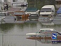 1998 Mercury Sable - Multiple vehicles are submerged in floodwaters, indicating a significant weather event.