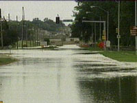 1998 Mercury Sable - Street flooded after heavy rain, traffic lights are visible.