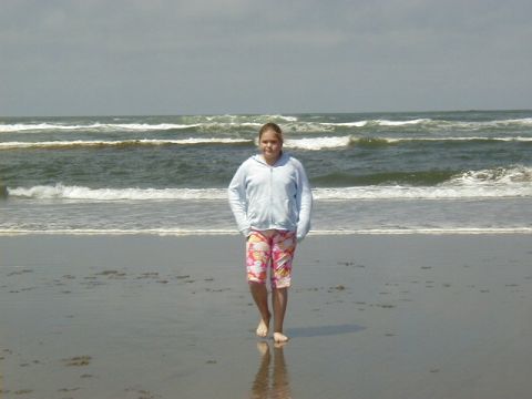 1994 Ford Explorer - A girl walks along the shoreline with the ocean in the background.