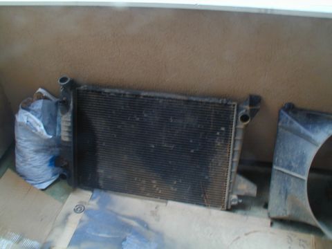 1988 Ford Bronco - Radiator and fan shroud shown against a wall.