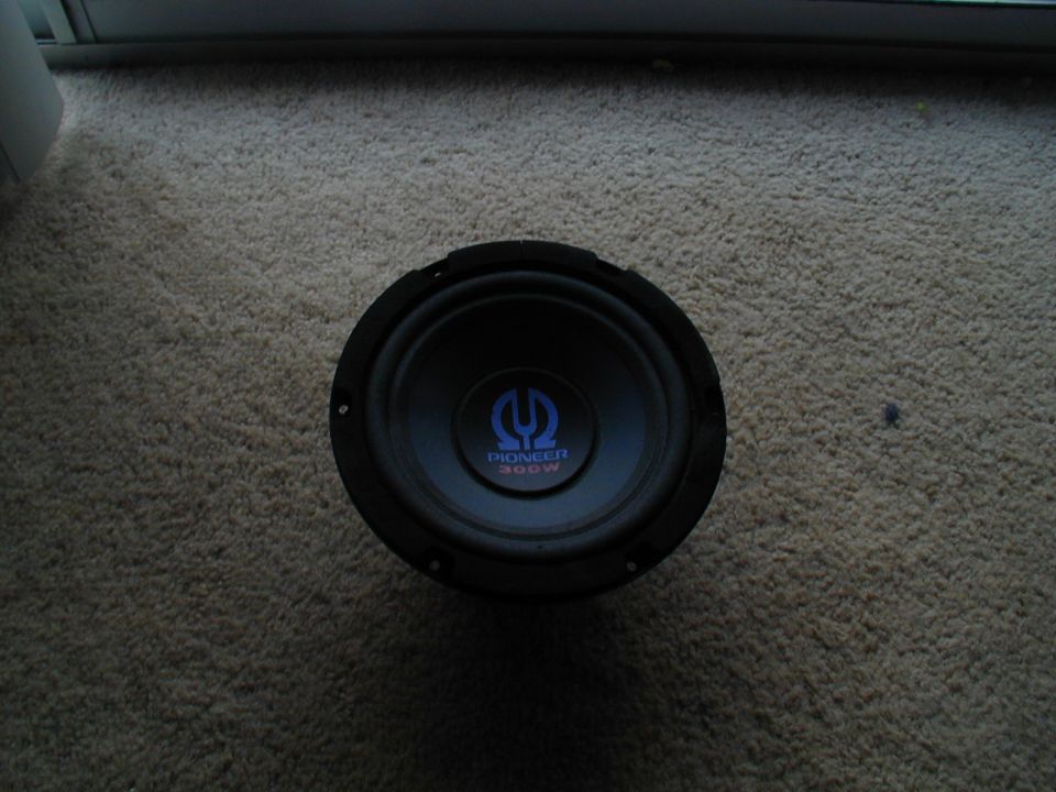 Black Pioneer 300W car speaker with blue logo on carpet