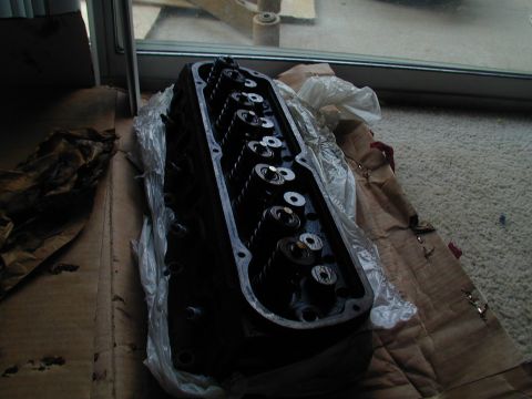 1988 Ford Bronco - A close-up view of an engine cylinder head, likely removed from a vehicle for repair or replacement.