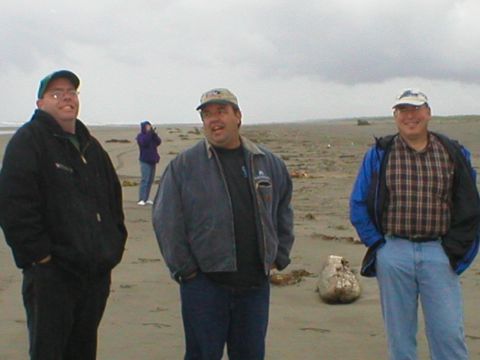 1978 Ford Bronco - Three men and a woman are on a beach with the ocean in the background.