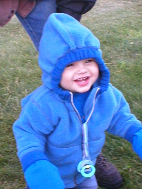 1978 Ford Bronco - A happy child wearing a blue hooded sweatshirt and mittens smiles while outdoors on a grassy area.