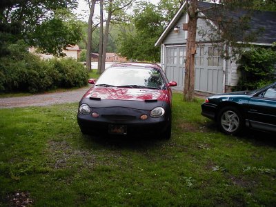 1997 Ford Taurus - This 1997 Ford Taurus is parked in front of a garage with a black bra covering its front end.