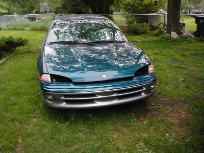 1997 Ford Taurus - This sedan is missing its headlights and appears to be in a yard.