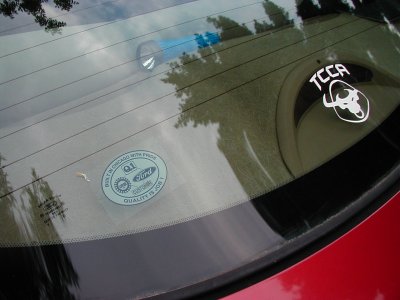 1997 Ford Taurus - A close-up of a car's rear window shows a Ford Quality is Job 1 sticker and a TCCA sticker.