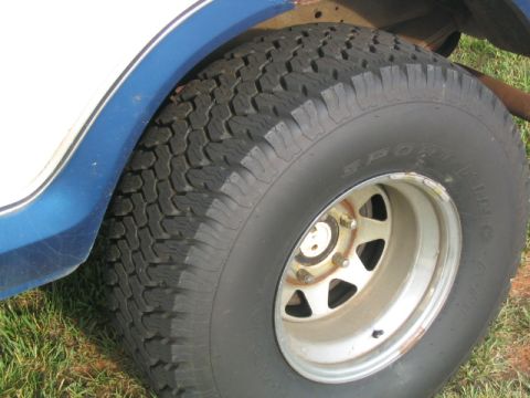 1978 Ford Bronco - Close-up view of a vehicle's tire and wheel well, showing the tread pattern and rim detail.