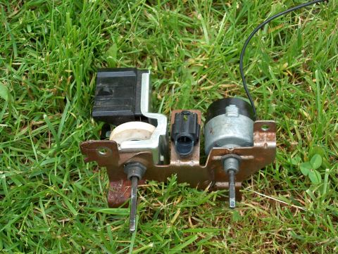 1990 Ford F-150 - This HVAC blower motor assembly is shown resting on a patch of grass.