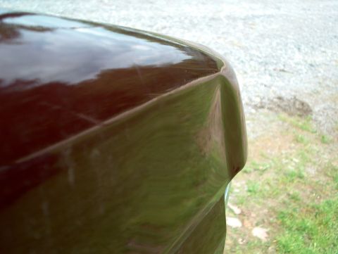 1990 Ford F-150 - Detail of a car's body panel, showing the curvature of the hood near the corner.