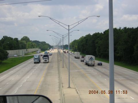 1984 Chevrolet Blazer - A busy highway scene with various vehicles on the road under a cloudy sky.