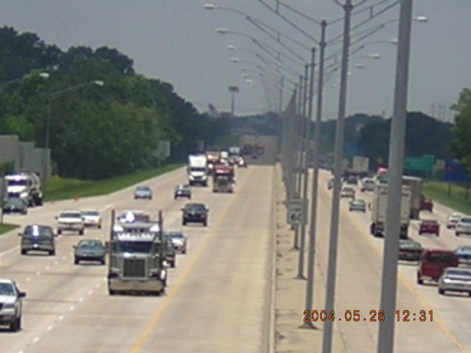 Traffic on a highway with trucks and cars. Date stamp shows 2004