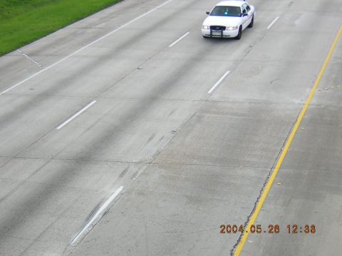 1984 Chevrolet Blazer - A white police car drives down a highway on May 28, 2004.