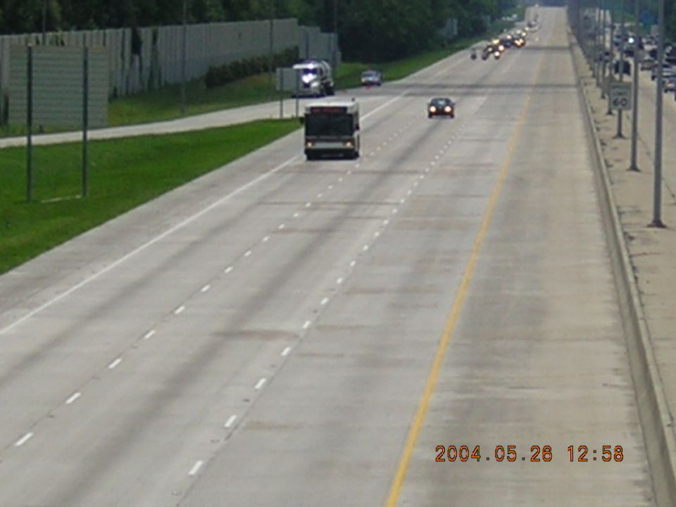 Highway scene with a bus, cars, and a truck