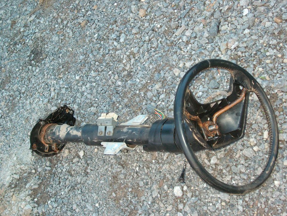 Steering column and wheel assembly lying on gravel