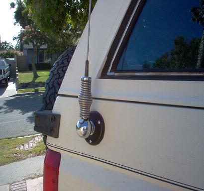 1988 Ford Bronco - A close-up view of the rear side of a 1988 Ford Bronco, showing an antenna and spare tire.