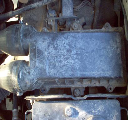 1988 Ford Bronco - Close-up view of a vehicle's engine air intake system components.