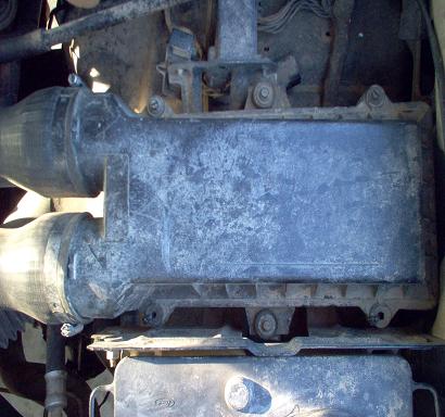 1988 Ford Bronco - Close-up view of an engine's air intake assembly and associated hoses.