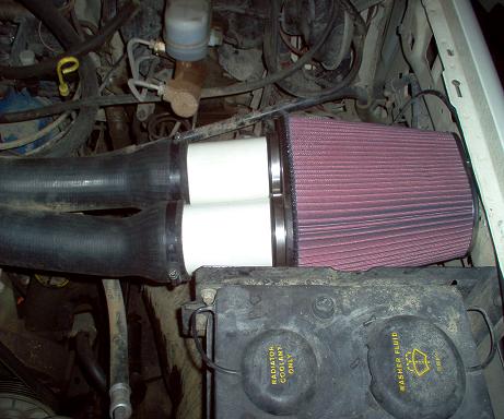 1988 Ford Bronco - Aftermarket K&N air filter installed in the engine bay with dual intake tubes.