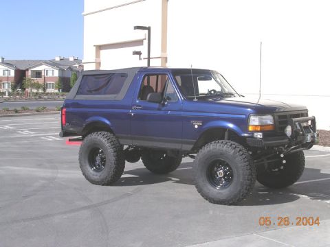 1994 Ford Bronco - This lifted Ford Bronco features a removable soft top and aggressive off-road tires, ready for adventure.