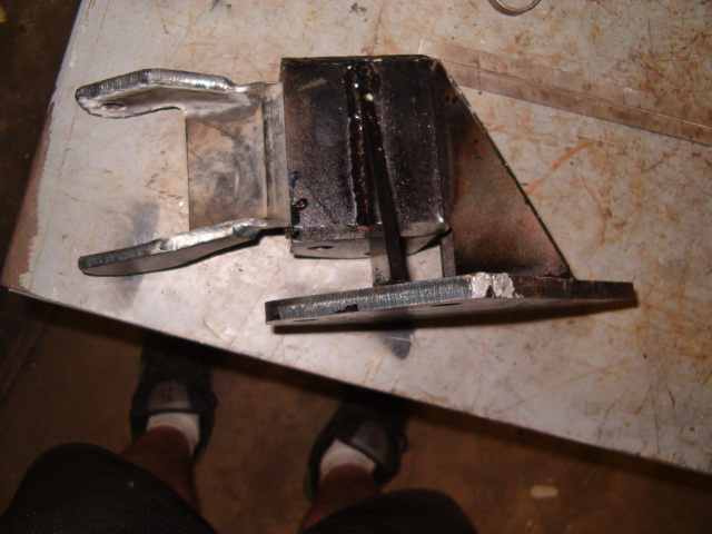 Welded metal part with two prongs and a triangular base
