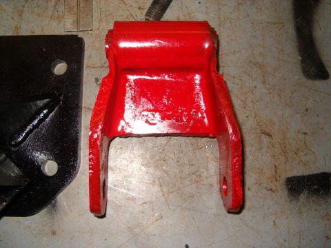 1988 Ford Bronco - Close-up of a red painted metal part, possibly a suspension component.