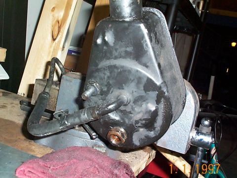 1992 Ford Bronco - Now I put it in a vise to remove the high pressure fitting and the other retaining bolt for the resevoir. The high pressure fitting takes a…