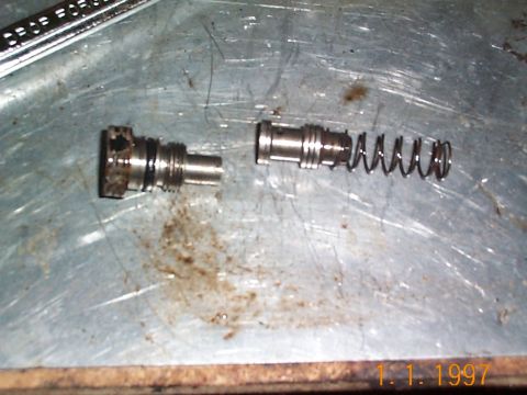 1992 Ford Bronco - High pressure fitting removed this is the flow valve behind it, flow valve should always be replaced. There is a seal on the high pressure…