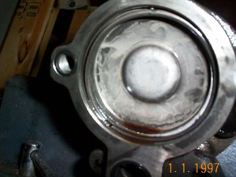 1992 Ford Bronco - Here the retaining ring is about to come out. Be careful as there is a spring behind this that will cause the plate to shoot out if you're…