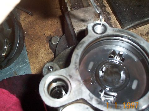 1992 Ford Bronco - Close-up of a disassembled power steering pump, showing its internal mechanisms and metal housing.