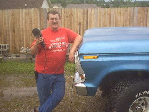 1991 Ford LTD Crown Victoria - Man poses with a blue pickup truck, holding an angle grinder.