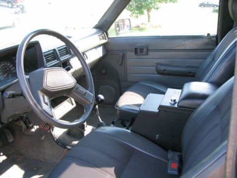 1986 Ford F-150 - The interior of a pickup truck is shown, the driver's side and passenger's side seats.