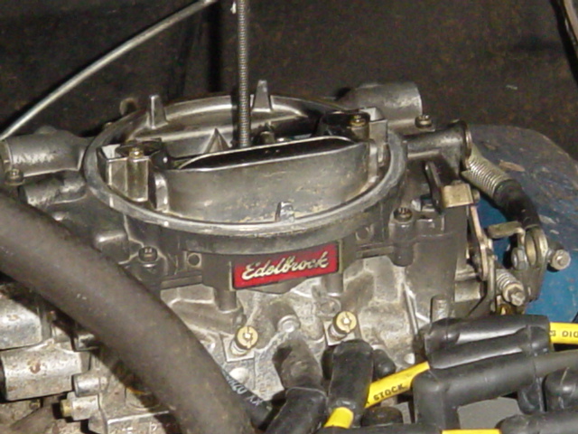 Edelbrock carburetor with red and silver badging
