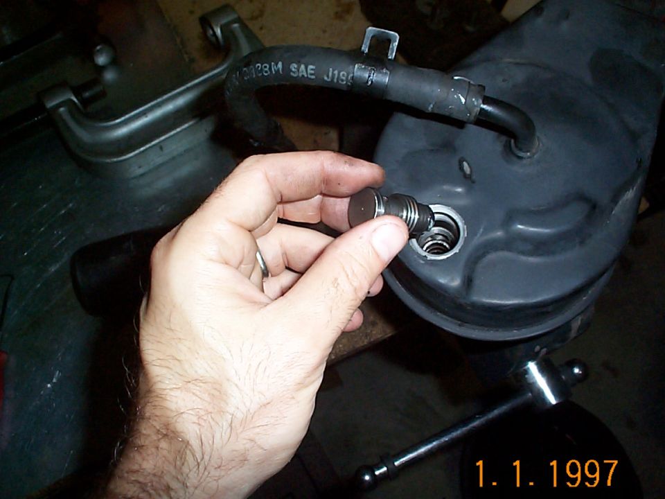 Reinsert the flow valve. It has been said you shouldn't reuse the flow valve. I cleaned mine of with carb cleaner and it was good to go.