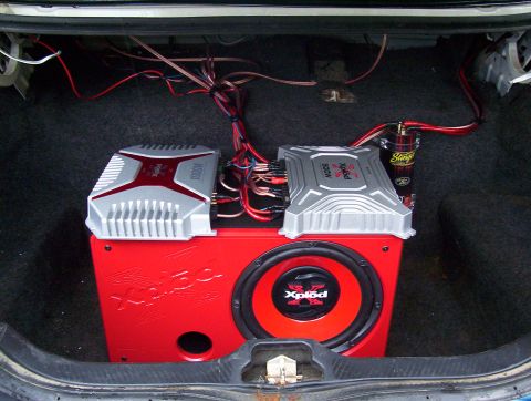 1995 Ford Crown Victoria - Car trunk interior with audio system installed, including amplifiers and subwoofer.