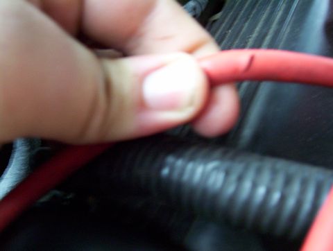1995 Ford Crown Victoria - A close-up shows a red wire with a visible cut.