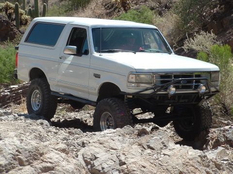 1990 Ford Bronco - This modified 1990 Ford Bronco tackles a challenging rocky trail, its off-road capabilities.